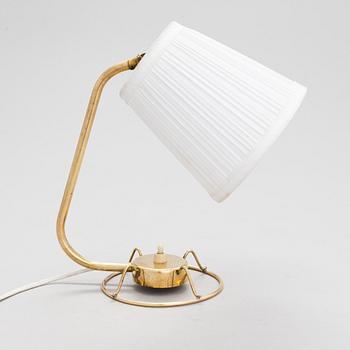 A mid-20th-century table lamp
/wall light for Idman.