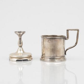 A Russian Silver Candlestick, 1908-26, and a Russian Silver Tea Glass Holder, assay master A. Skovronsky, Moscow 1896.