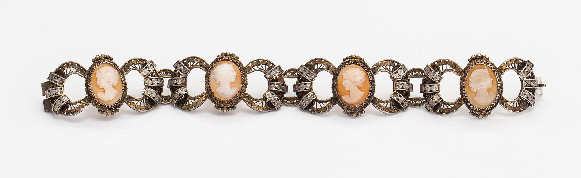 A silver and sea shell cameo bracelet.