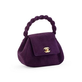 CHANEL, a purple suede evening bag.