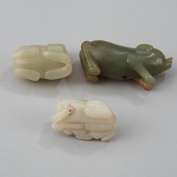 Three Chinese nephrite figure of two buddhist lions and a pig.