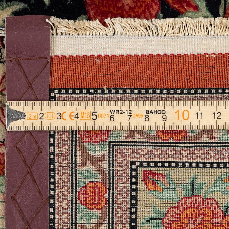 A signed silk Qum rug. c. 154 x 103 cm.