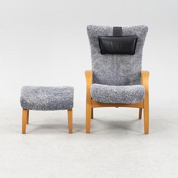 A 'Delta Adventure' wingback armchair and foot stool from Brunstad AS, Norway.