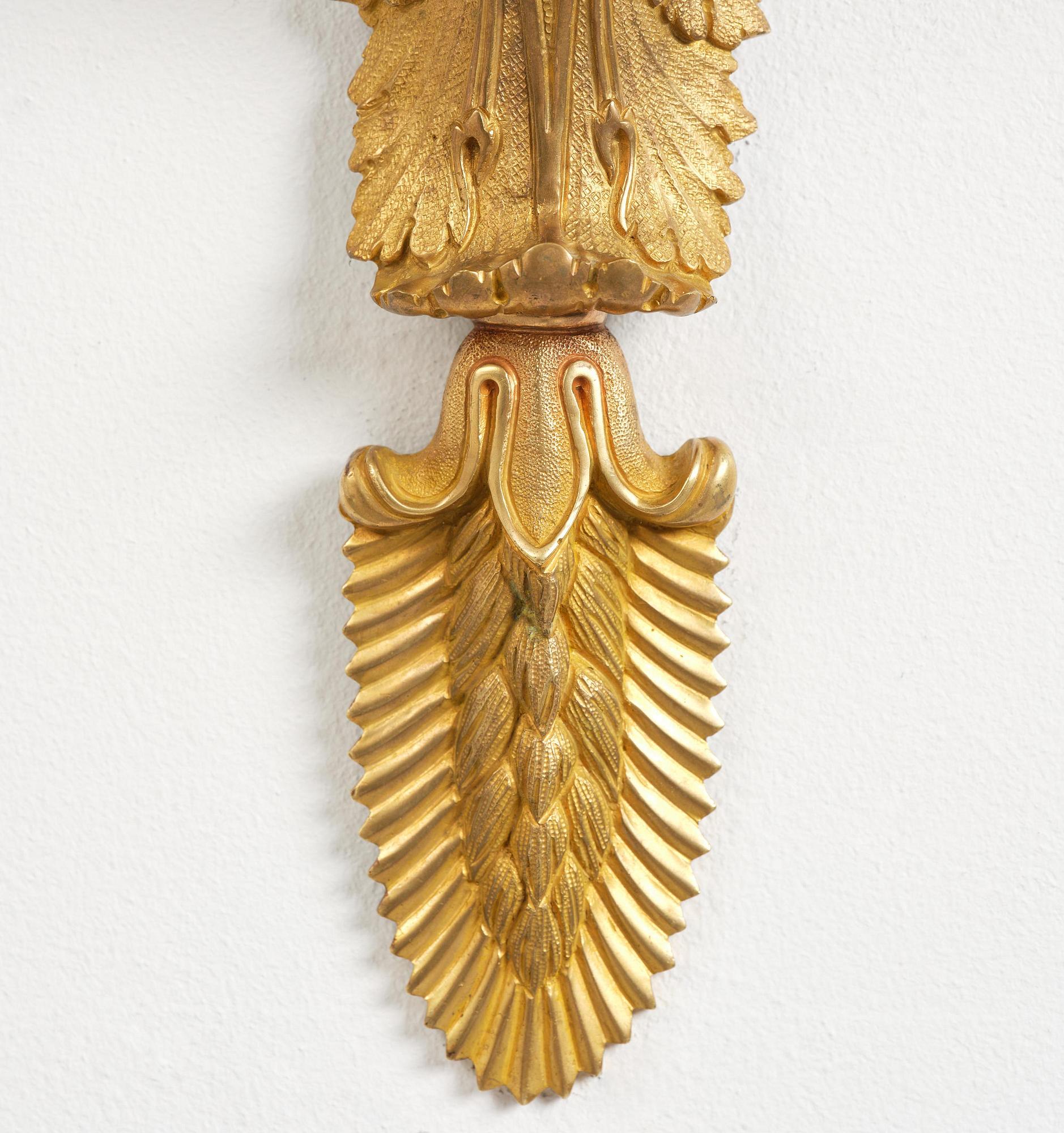 A pair of Napoleon III five-branch gilt and patinated bronze appliques.