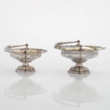 A set of two 1920s-1930s silver sweetmeat basket with sugar tong and jam spoon, Uusi Kultaseppä Oy, Helsinki, Finland.