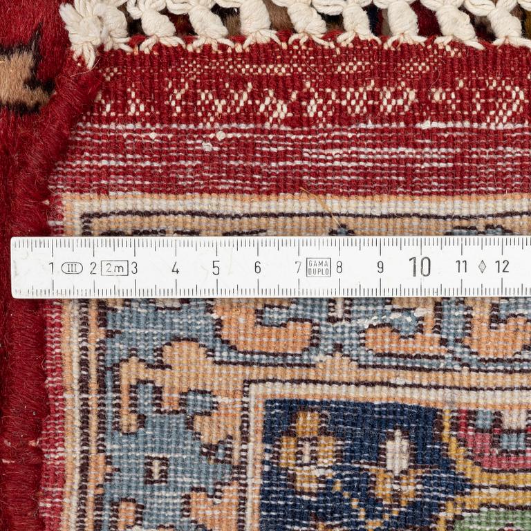 An oriental rug, c. 245 x 150 cm.