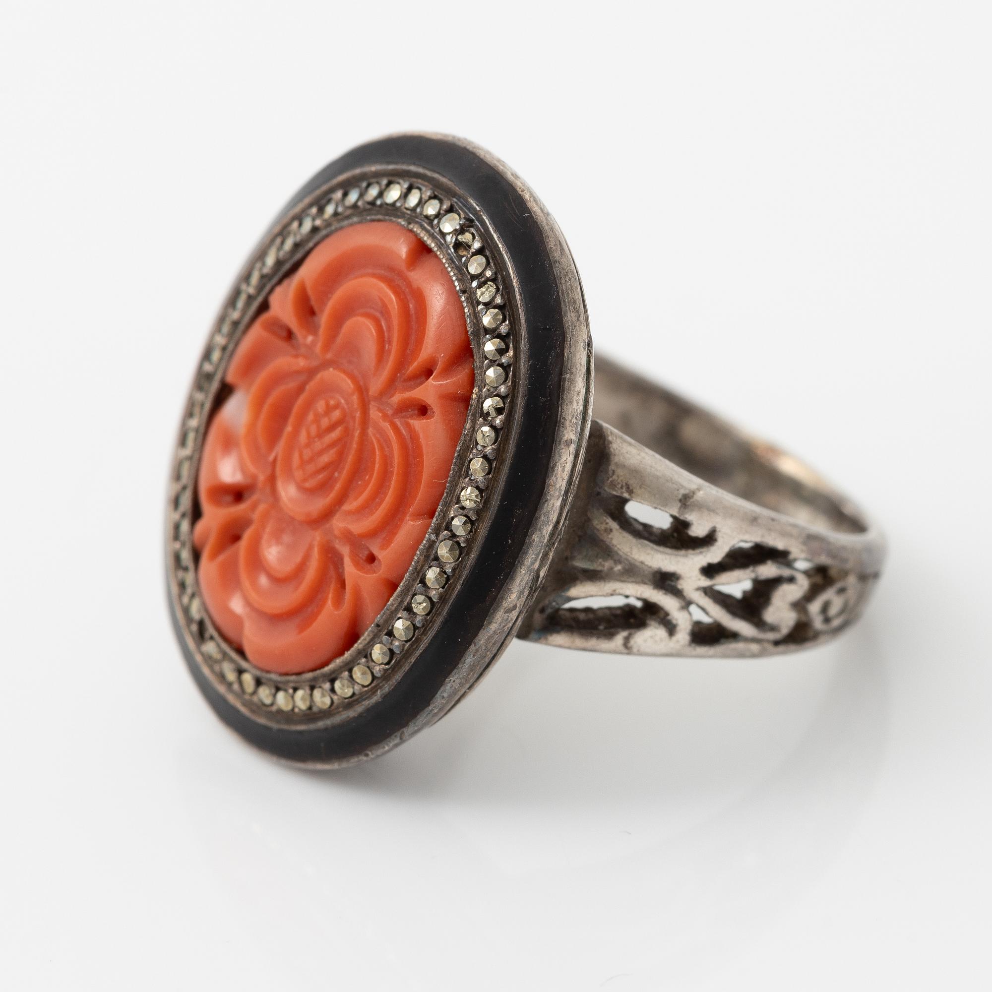 Silver ring with coral and marcasites and with black details.