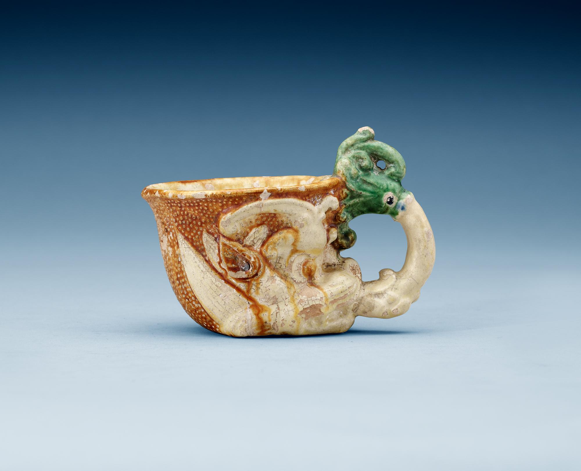 A green white and yellow glazed rhyton ewer, Tang dynasty (618-907).