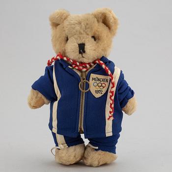 Olympic memorabilia: A teddy bear and four silvercoins from