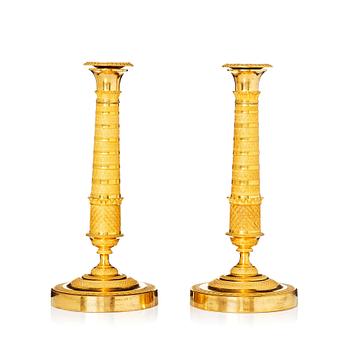 145. A pair of Empire candlesticks, early 19th century.
