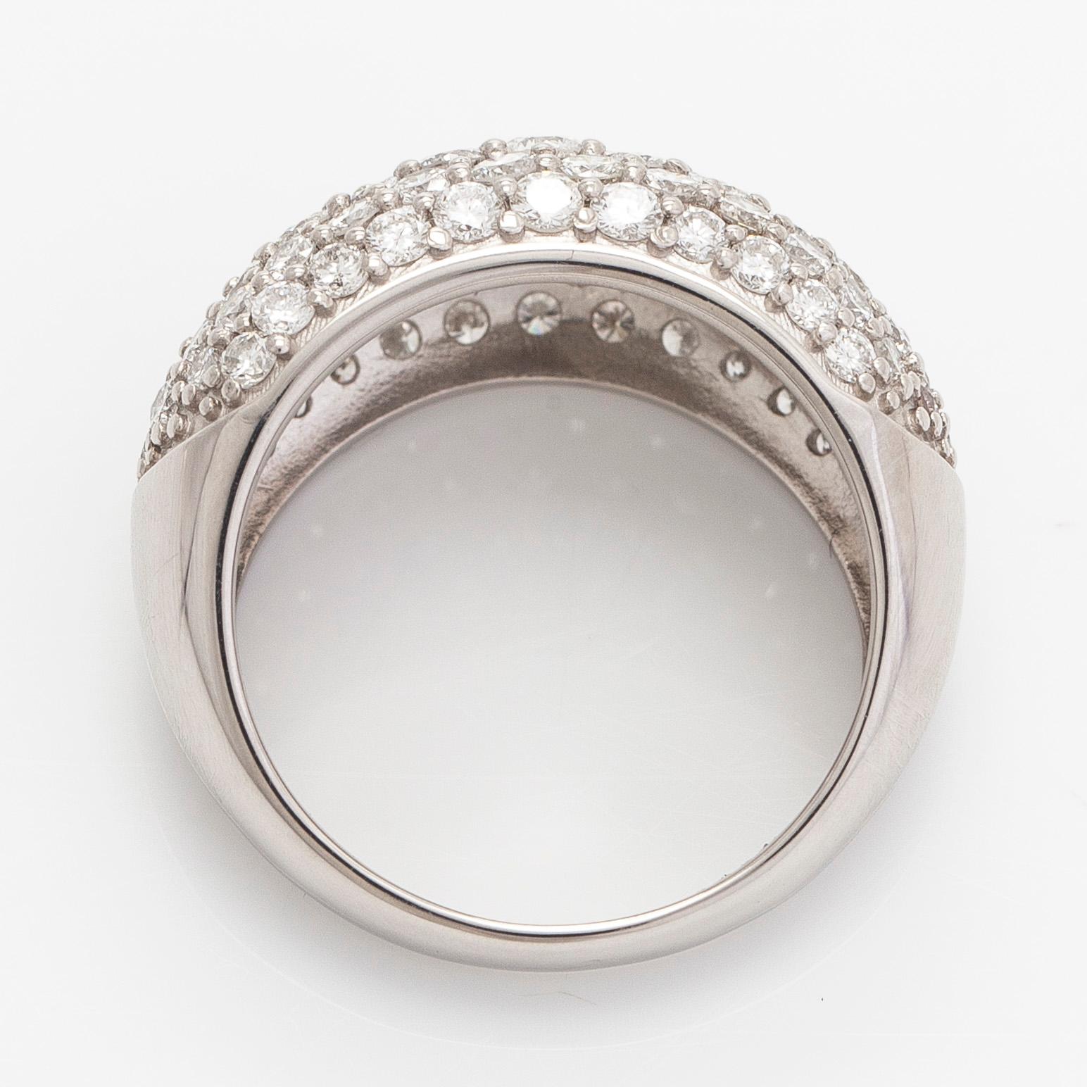 A platinum bombé ring with brilliant-cut diamonds.