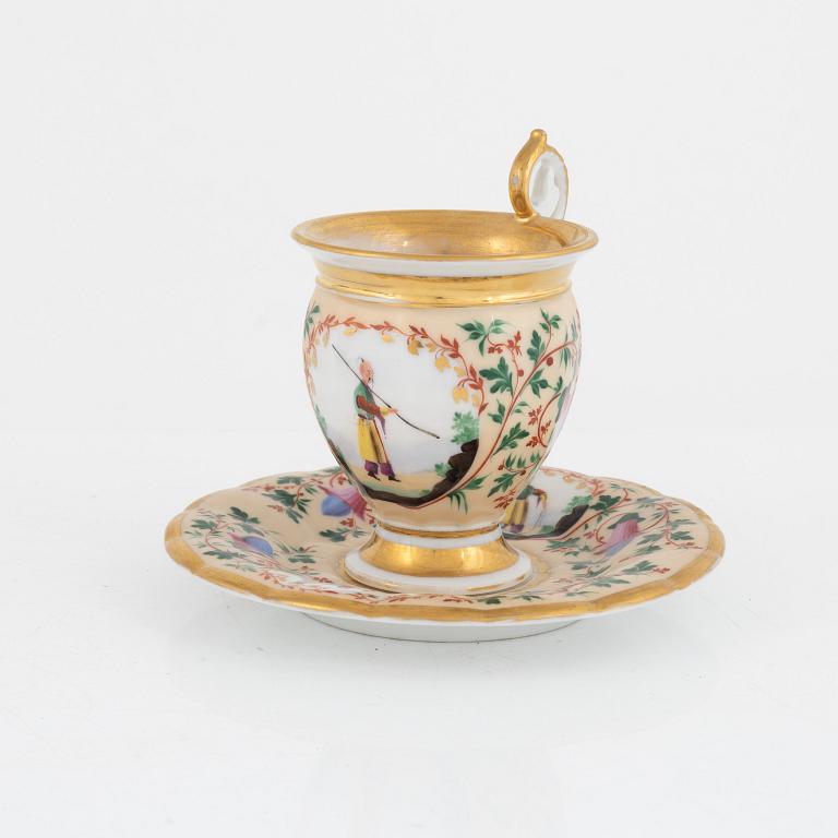 Two Empire porcelain cups with stands, 19th century.