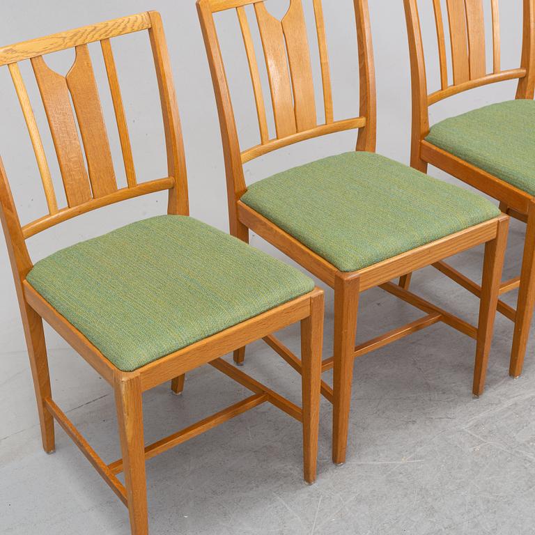 An oak dining table and four chairs by Carl Malmsten for Bodafors. Second half of the 20th Century.