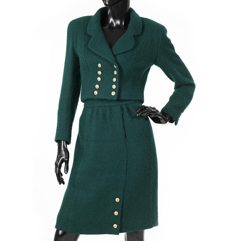 CHANEL, a two-piece suit consisting of short jacket and skirt.