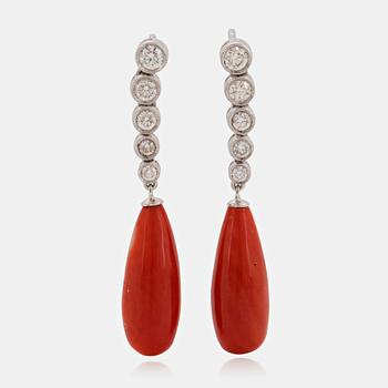 1044. A pair of 18K white gold earrings with coral drops and round brilliant-cut diamonds.