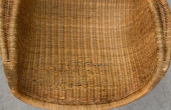 A 1950's pair of rattan easy chairs.