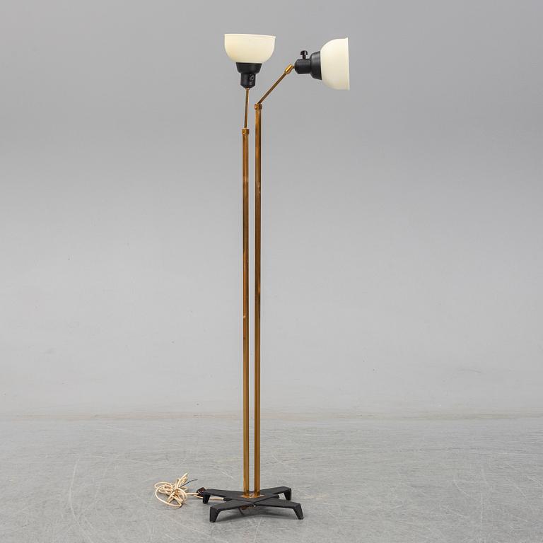 A 1950s brass and glass floor lamp.