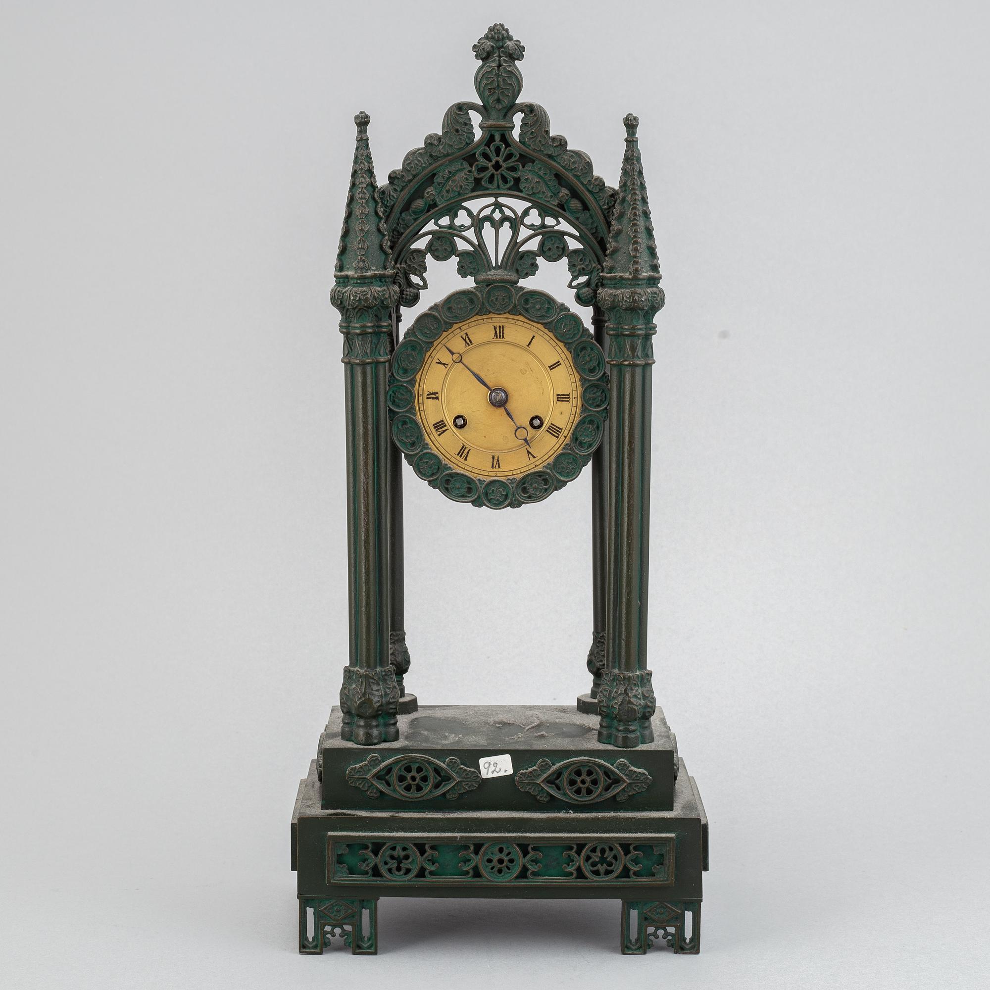 A cast iron gothic revival mantel clock, late 19th century.