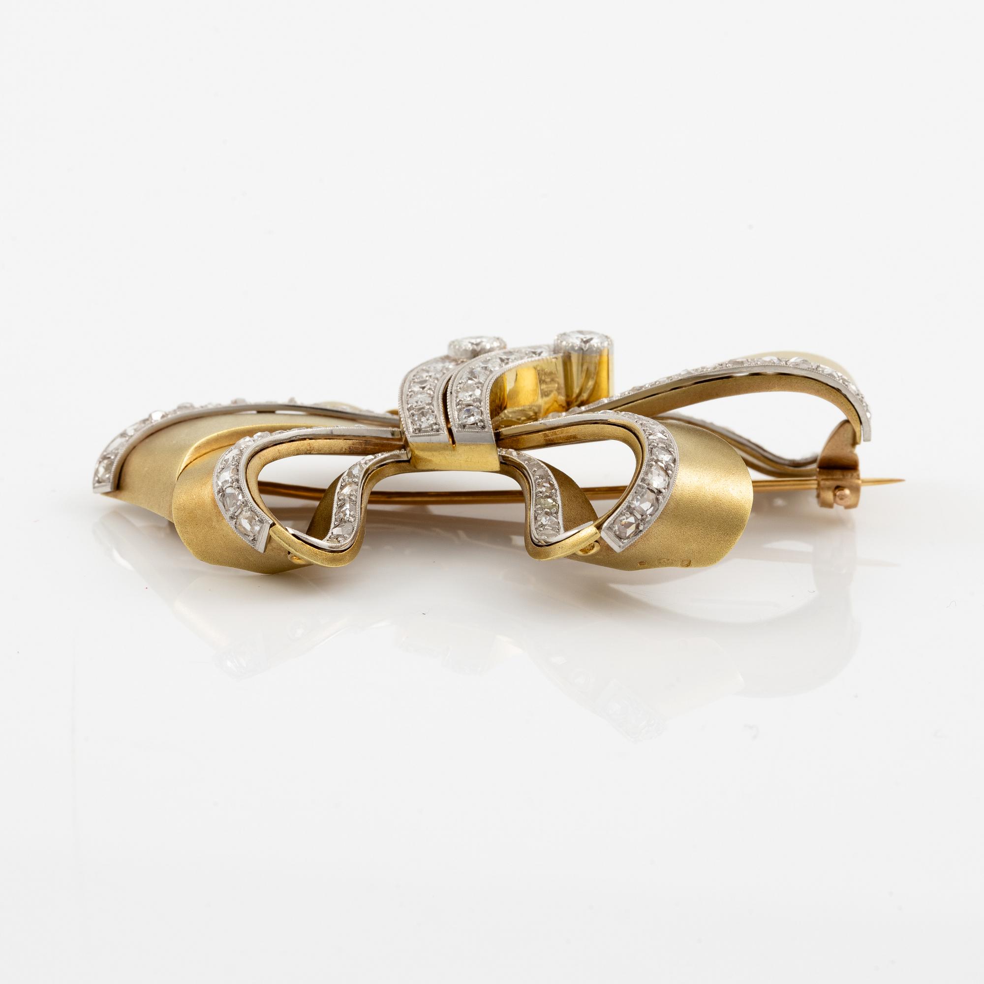 Bow brooch in 18K gold and platinum set with round brilliant, eight-cut, and rose-cut diamonds.
