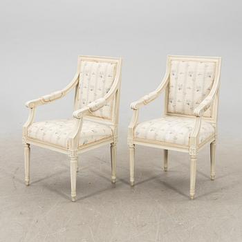 A pair of Gustavian style painted armchairs from around 1900.