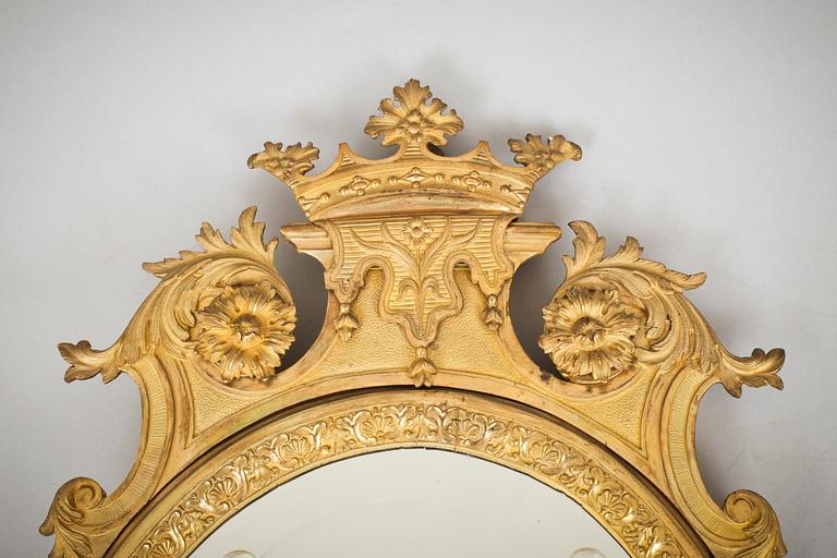 A pair of late Baroque-style circa 1900 gilt bronze two-light girandole mirrors.