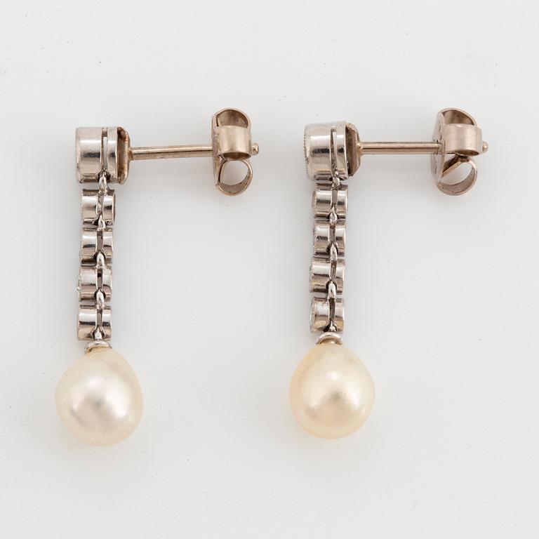 A pair of platinum and 18K white gold earrings set with pearls and old- and eight-cut diamonds.