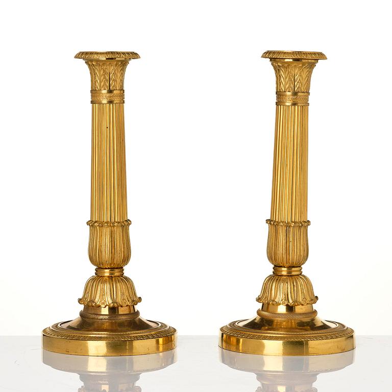 A pair of French Empire gilt-bronze candlesticks, early 19th century.