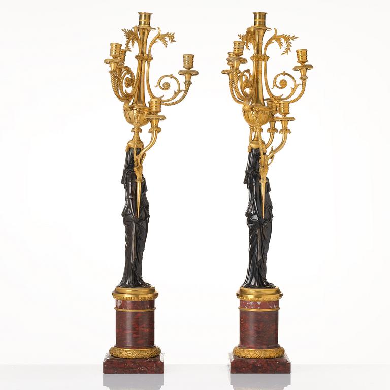 A pair of Louis XVI ormolu and patinated bronze six-branch candelabra attributed to François Rémond, late 18th century.