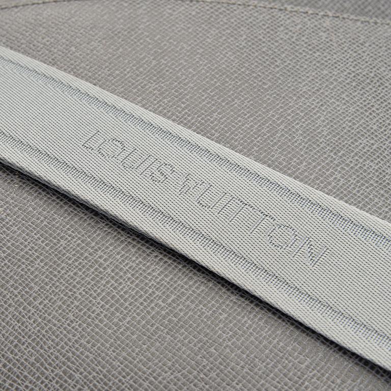 Louis Vuitton, a Taiga leather 'Roman MM' bag.