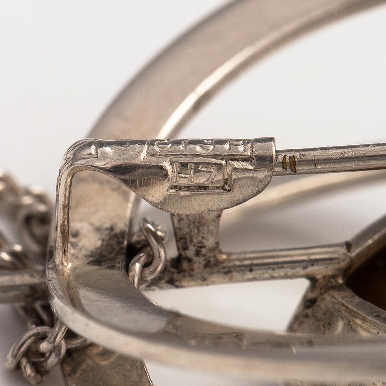Elis Kauppi, A silver necklace/brooch with a tiger's eye. Kupittaan kulta, turku 1961.