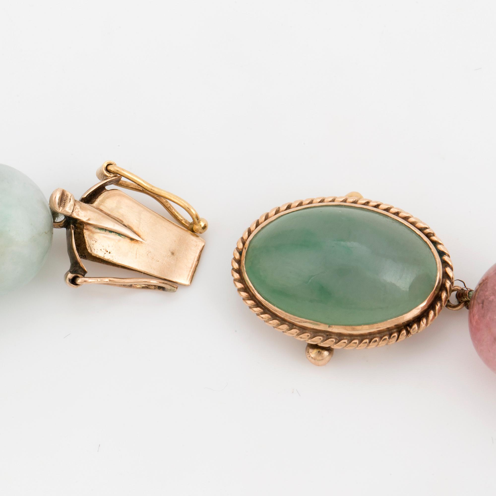 A necklace of multi-coloured stone beads with an 14K gold clasp.