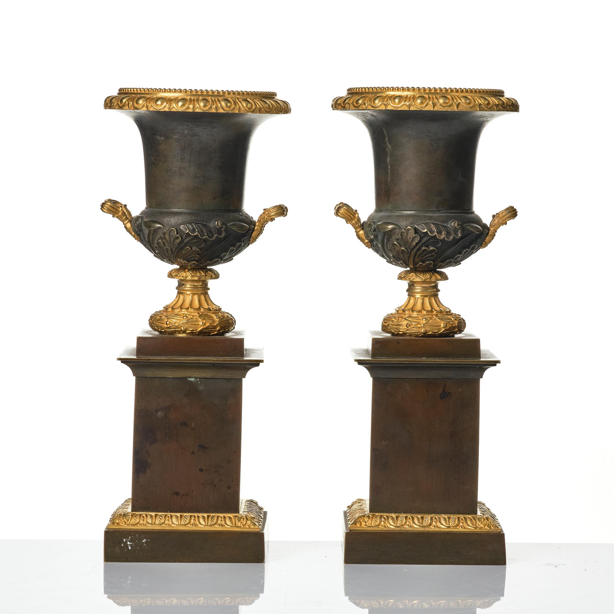 A pair of French Louis Philippe gilt and patinated bronze urns, first part 19th century.