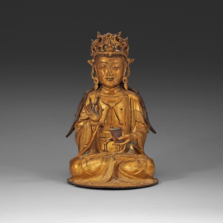 A gilt-bronze figure of a seated Guanyin, Ming dynasty (1368-1644).