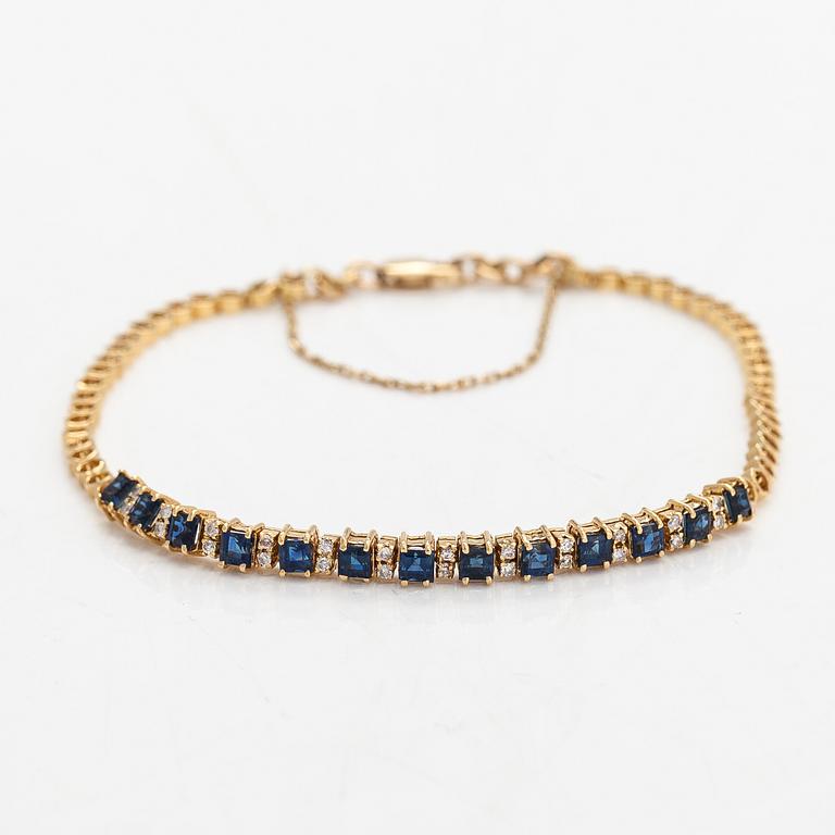 Rannkoru, 14K kultaa, timantteja n. 0.12 ct yht ja safiireja.