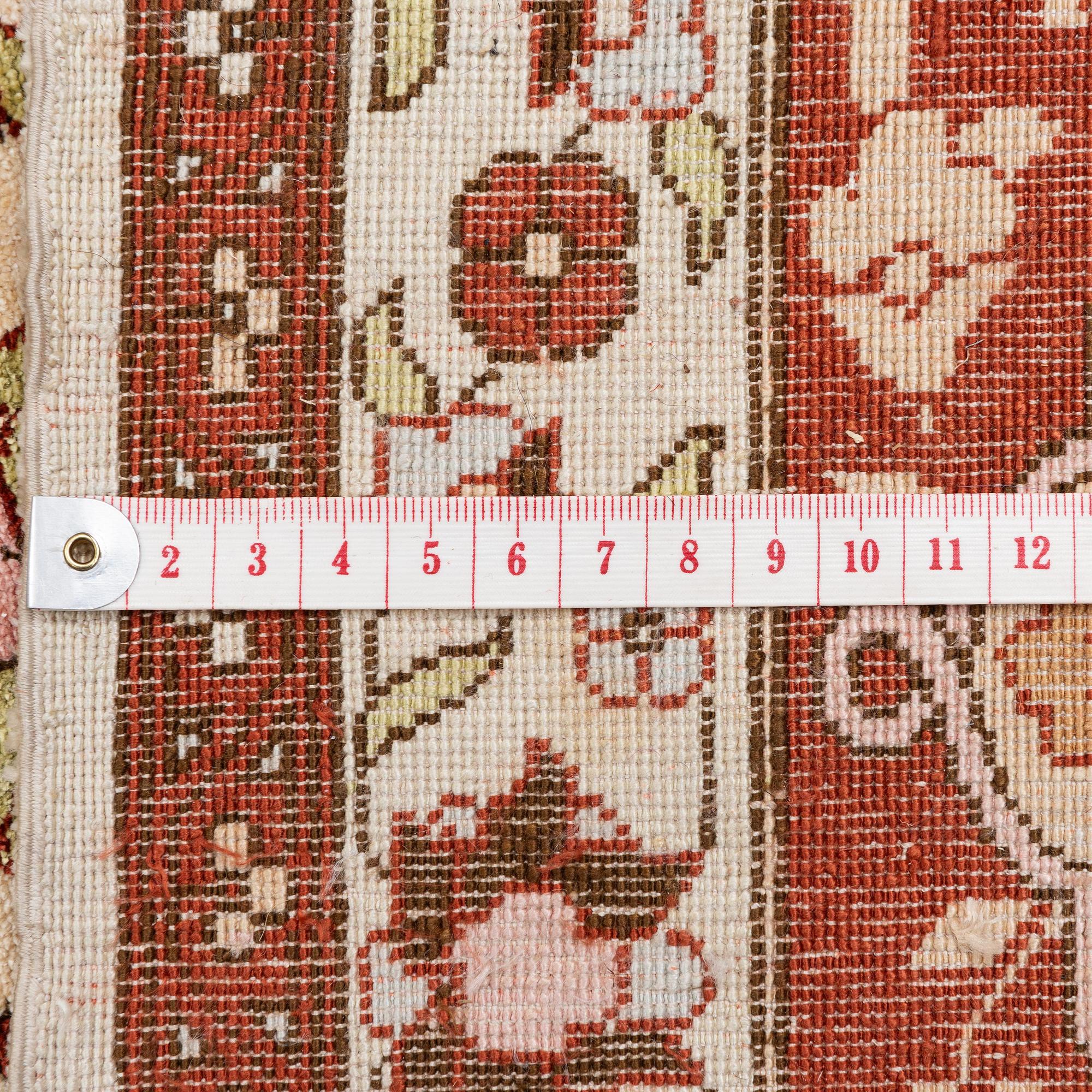 A semi-antique Turkish silk rug, c. 200 x 130 cm.