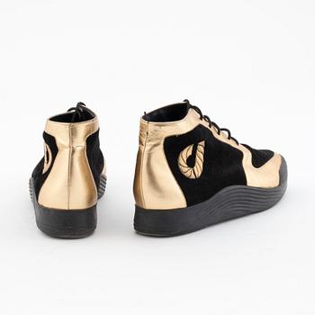 CHARLES JOURDAN, a pair of black suede and gold colored leather sneakers.