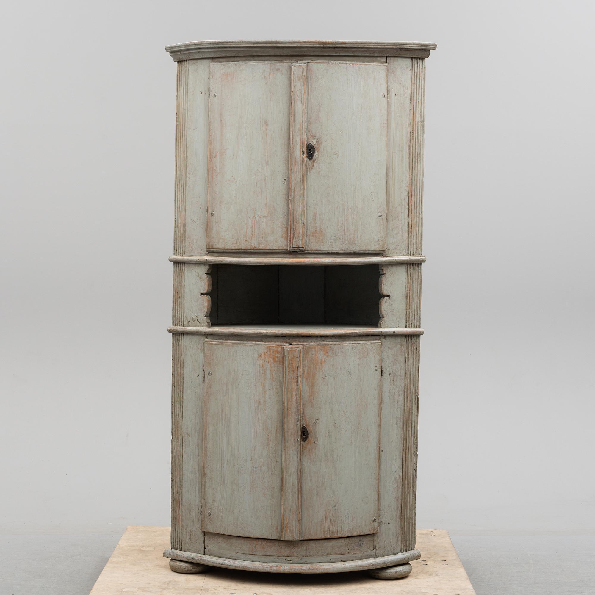 A first half of the 19th century painted corner cabinet.