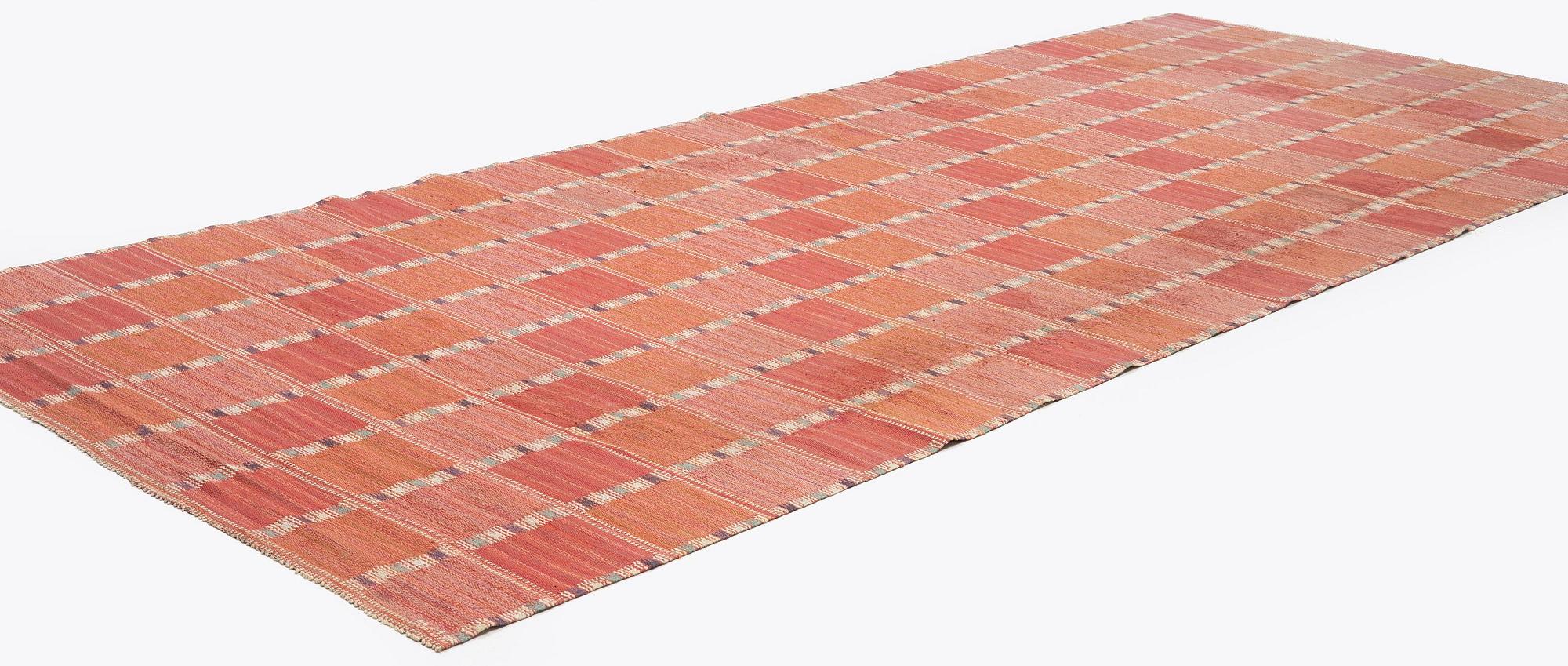 Barbro Nilsson, a carpet, 'Falurutan, röd Borås', flat weave, c. 502 x 212 cm, signed AB MMF BN.