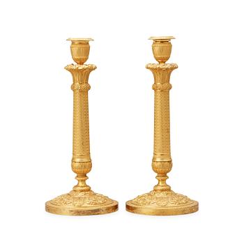 1458. A pair of French Empire early 19th century gilt bronze candlesticks.