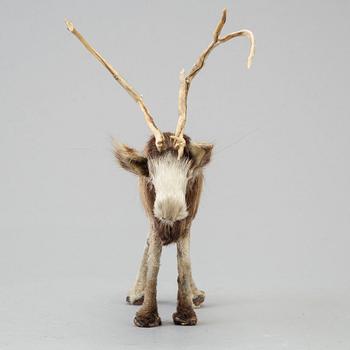 A Sami reindeer fur figure of a reindeer.