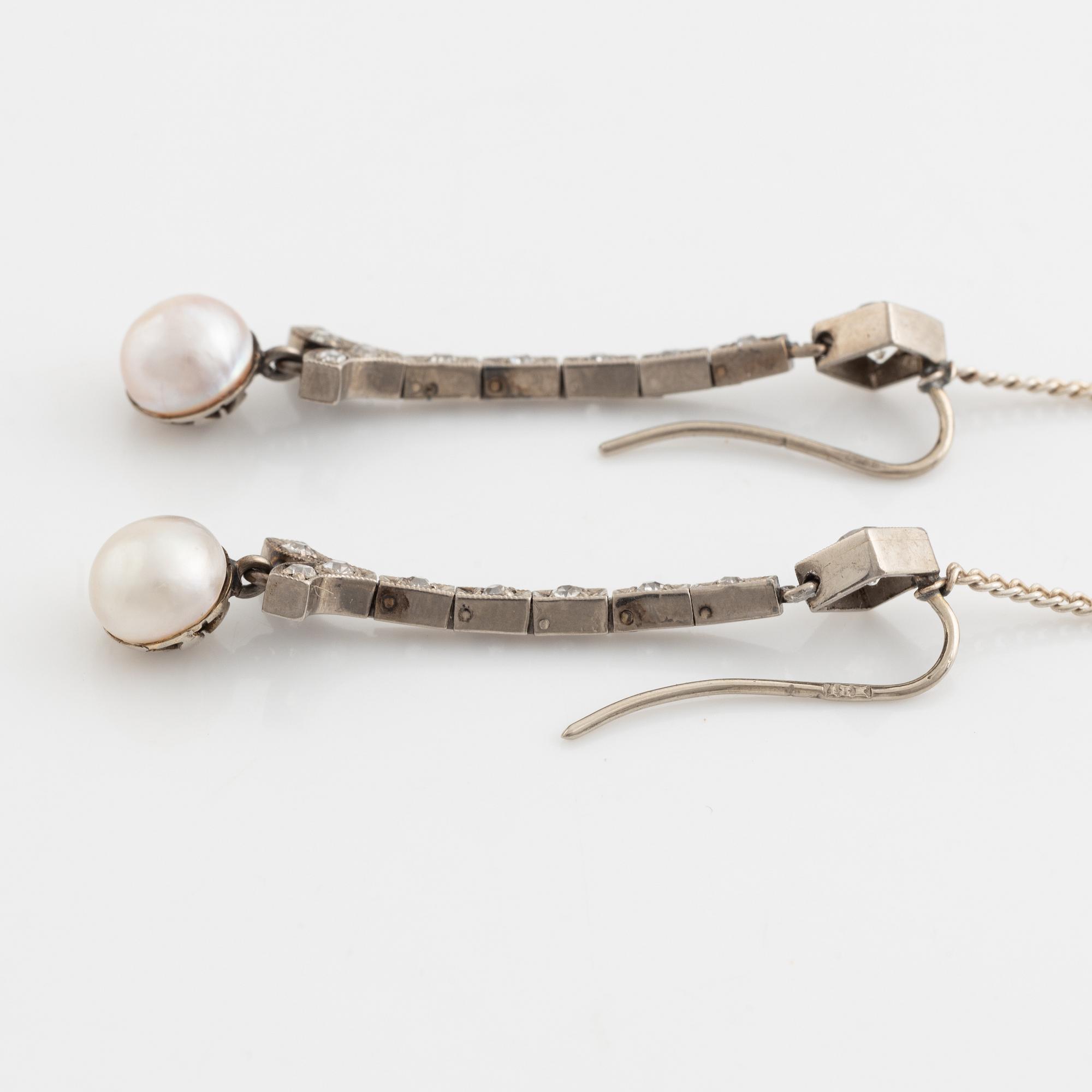 A pair of 18K gold and cultured halfpearl and diamond earrings.