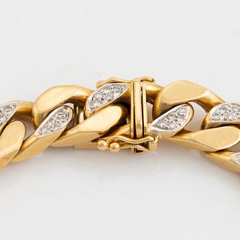 18K gold and brilliant cut diamond curb link bracelet.