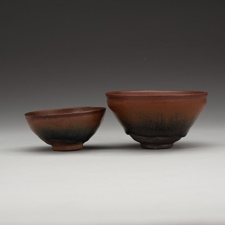 Two temmoku tea bowls, with 'hare's fur' glaze, the glaze pooling short of the unglazed feet. Song dynasty (960-1279).