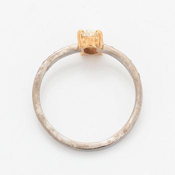 Oval diamond and brilliant-cut diamond ring.