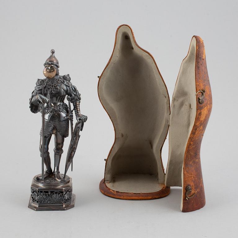 A silver knight figurine in case, pseudo marks.