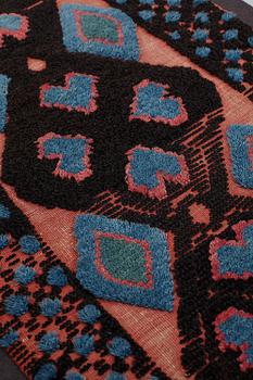 A carrige cushion, knotted pile in relief, ca 43,5 x 100 cm (with mounting 51 x 107,5 cm), southwestern Scania, Sweden.