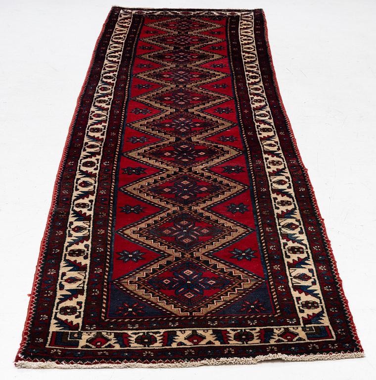 An oriental runner, c. 395 x 100 cm.
