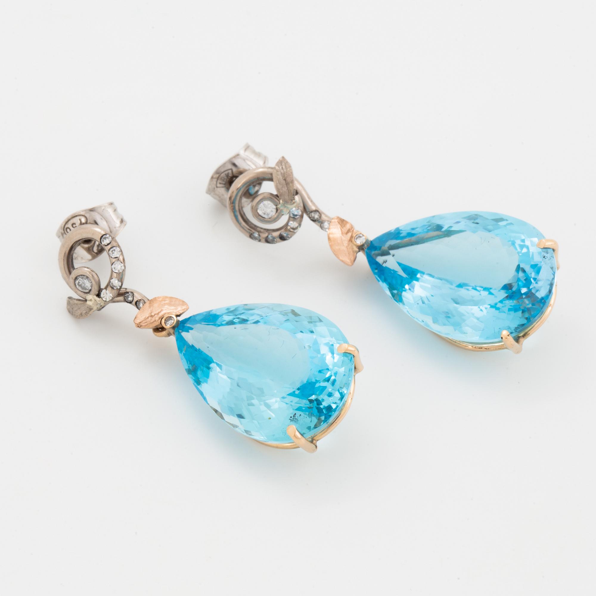 Drop shaped blue topaz and diamond earrings.