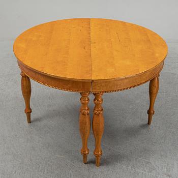 A mid 19th century birch dining table.