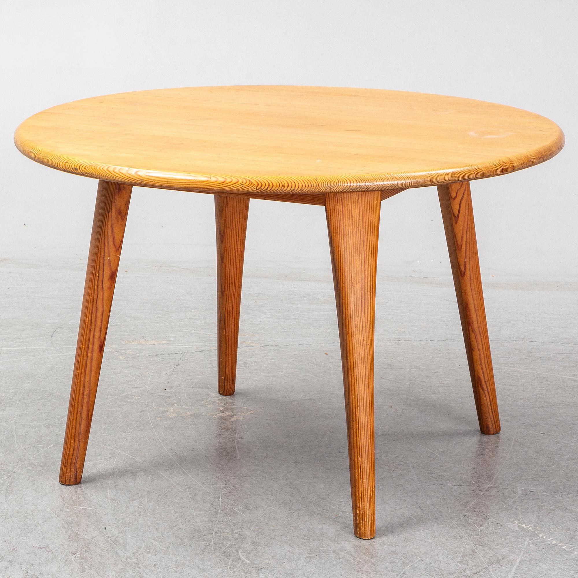 A Swedish 1960s pinewood round sofa table, design CARL MALMSTEN.